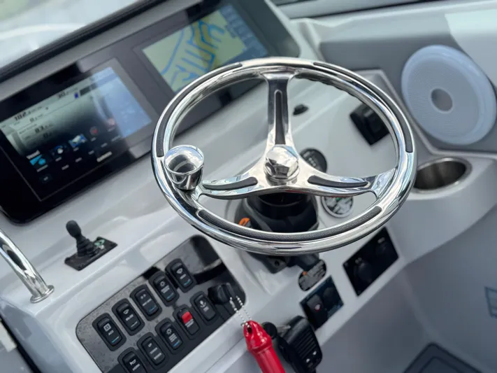  Yacht Photos Pics 2024 Regal 26 XO boat dashboard with steering wheel and control panel.