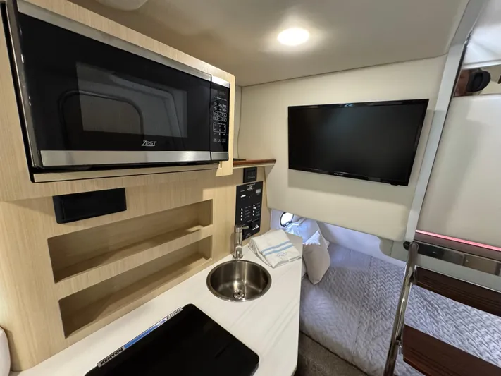  Yacht Photos Pics 2024 Regal 26 XO cabin interior with microwave, sink, and TV.