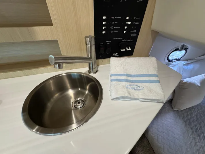  Yacht Photos Pics 2024 Regal 26 XO boat interior with sink, faucet, and control panel.