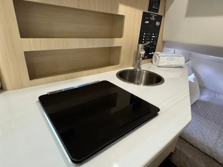  Yacht Photos Pics 2024 Regal 26 XO cabin interior with sink, control panel, and countertop.