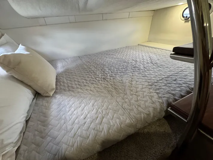  Yacht Photos Pics 2024 Regal 26 XO cabin interior with cozy bed and soft lighting.