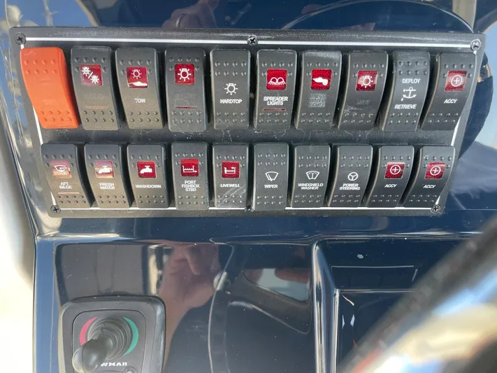  Yacht Photos Pics Control panel of a 2020 Pursuit S 288 boat with various switches and buttons.