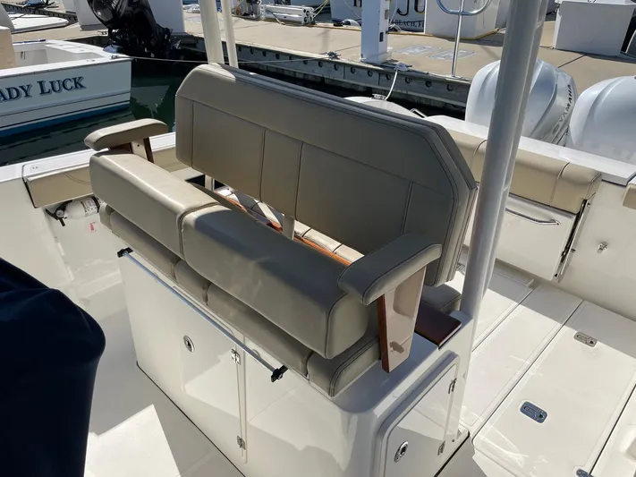  Yacht Photos Pics 2020 Pursuit S 288 boat interior with cushioned seating and storage compartments.
