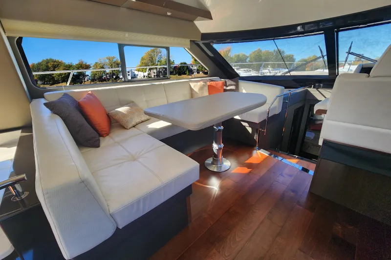  Yacht Photos Pics Luxurious interior of 2021 Carver 52 Command Bridge yacht with elegant seating and table.