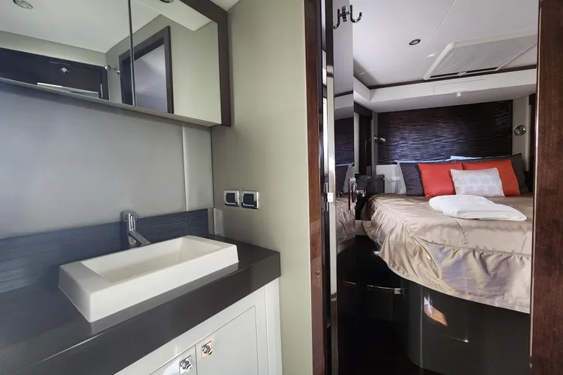  Yacht Photos Pics Luxurious interior of 2021 Carver 52 Command Bridge yacht, featuring a modern bathroom and cozy bedroom.