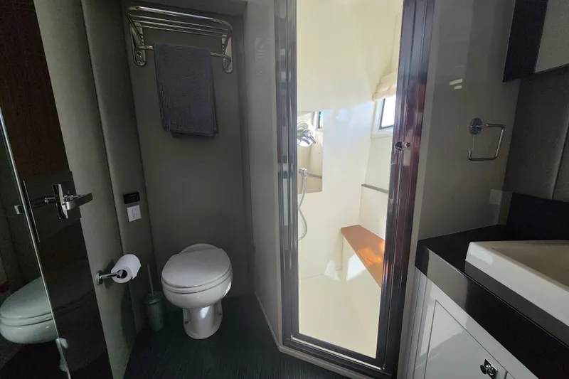  Yacht Photos Pics Bathroom interior of 2021 Carver 52 Command Bridge yacht, featuring toilet and shower.