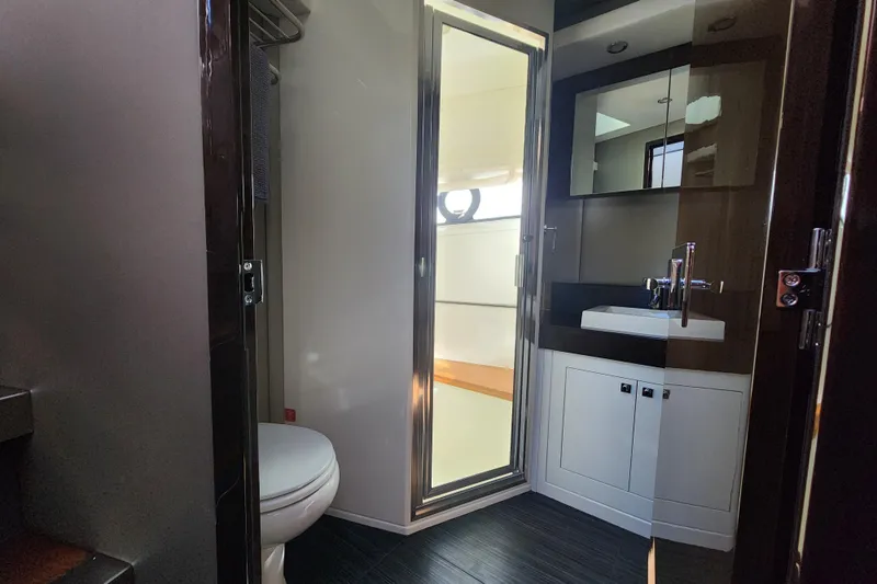  Yacht Photos Pics Bathroom interior of 2021 Carver 52 Command Bridge yacht, featuring modern fixtures and sleek design.