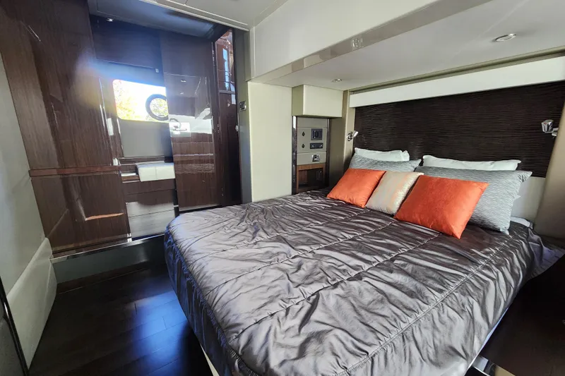  Yacht Photos Pics Luxurious bedroom interior of 2021 Carver 52 Command Bridge yacht with modern design.