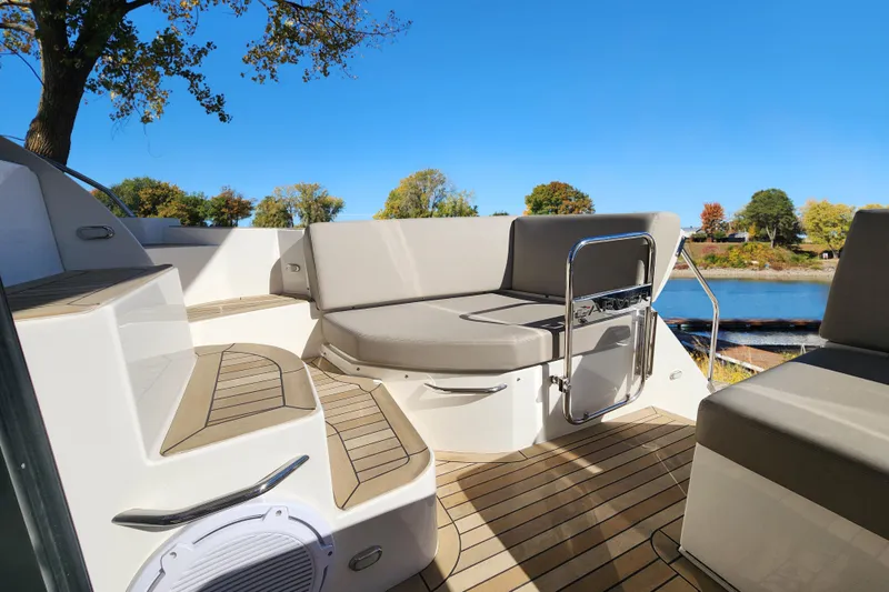  Yacht Photos Pics 2021 Carver 52 Command Bridge yacht deck with seating, overlooking serene water and trees.