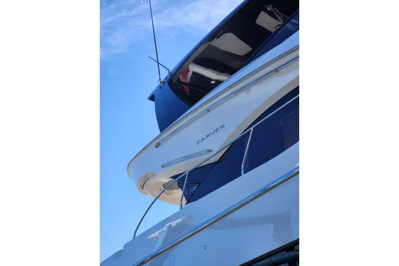  Yacht Photos Pics 2021 Carver 52 Command Bridge yacht against a clear blue sky.