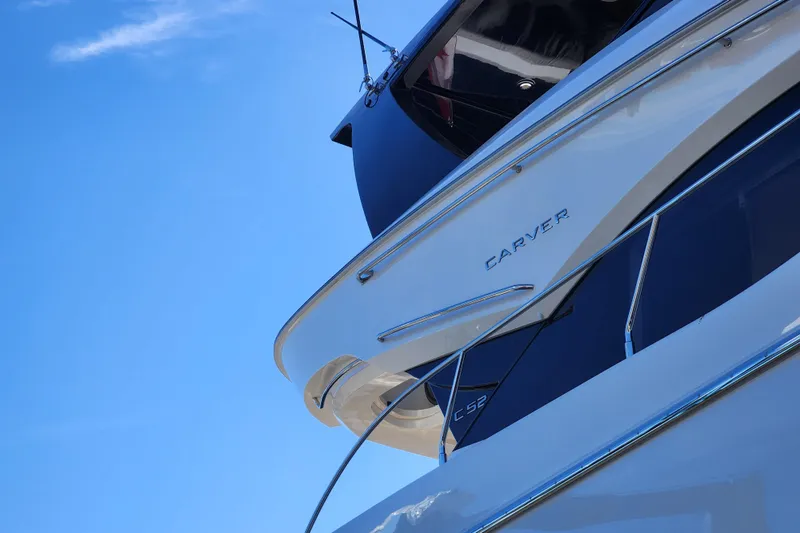  Yacht Photos Pics 2021 Carver 52 Command Bridge yacht against clear blue sky.