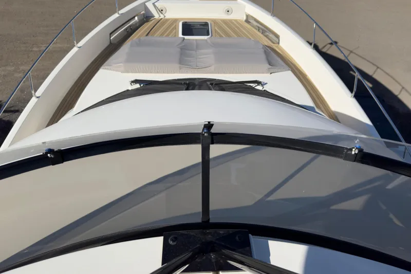  Yacht Photos Pics 2021 Carver 52 Command Bridge yacht deck with sunbed and sleek design.