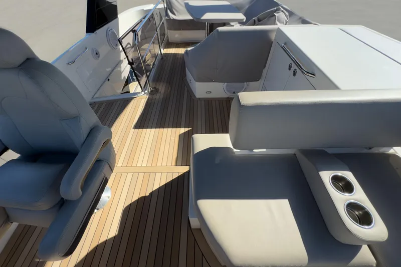  Yacht Photos Pics 2021 Carver 52 Command Bridge interior with luxurious seating and wooden flooring.