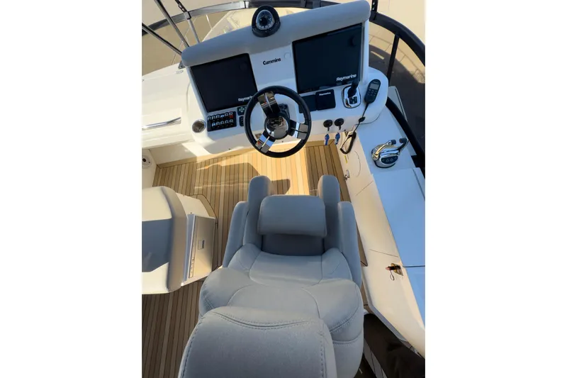 Yacht Photos Pics 2021 Carver 52 Command Bridge helm with modern controls and comfortable seating.