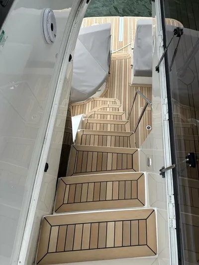  Yacht Photos Pics Staircase on 2021 Carver C52 Command Bridge yacht with teak decking.