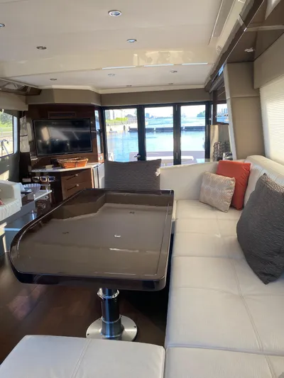  Yacht Photos Pics Luxurious interior of 2021 Carver C52 Command Bridge yacht with elegant seating and dining area.