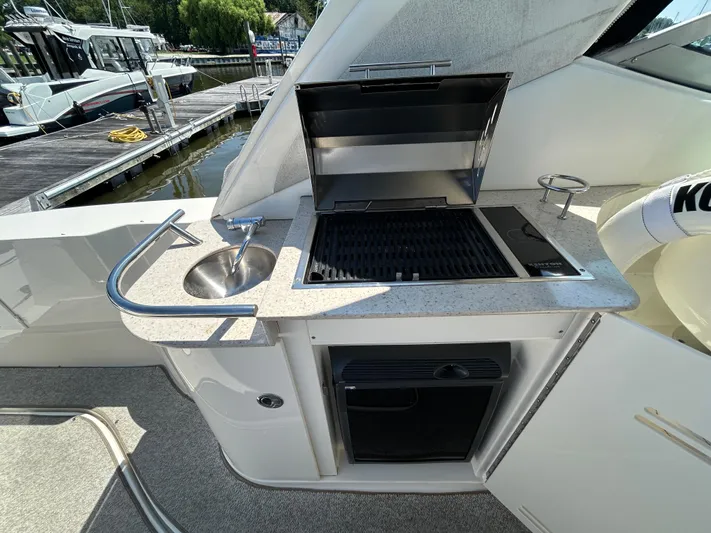  Yacht Photos Pics Outdoor kitchenette on 2008 Sea Ray 330 Sundancer yacht with grill and sink.