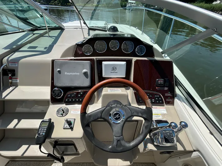  Yacht Photos Pics 2008 Sea Ray 330 Sundancer helm with Raymarine navigation, steering wheel, and control panel.