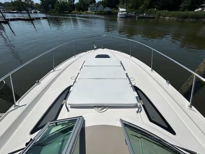  Yacht Photos Pics 2008 Sea Ray 330 Sundancer yacht on calm water, featuring spacious deck and sleek design.