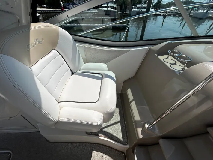  Yacht Photos Pics 2008 Sea Ray 330 Sundancer cockpit with white seating and cup holders, docked at marina.