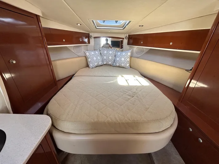  Yacht Photos Pics Luxurious cabin interior of 2008 Sea Ray 330 Sundancer yacht with cozy bed and wooden cabinets.