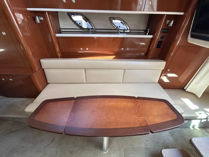  Yacht Photos Pics Interior of 2008 Sea Ray 330 Sundancer with wooden table and beige seating.