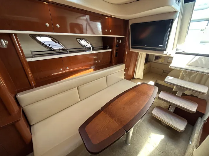  Yacht Photos Pics Luxurious interior of 2008 Sea Ray 330 Sundancer yacht with sofa, table, and TV.
