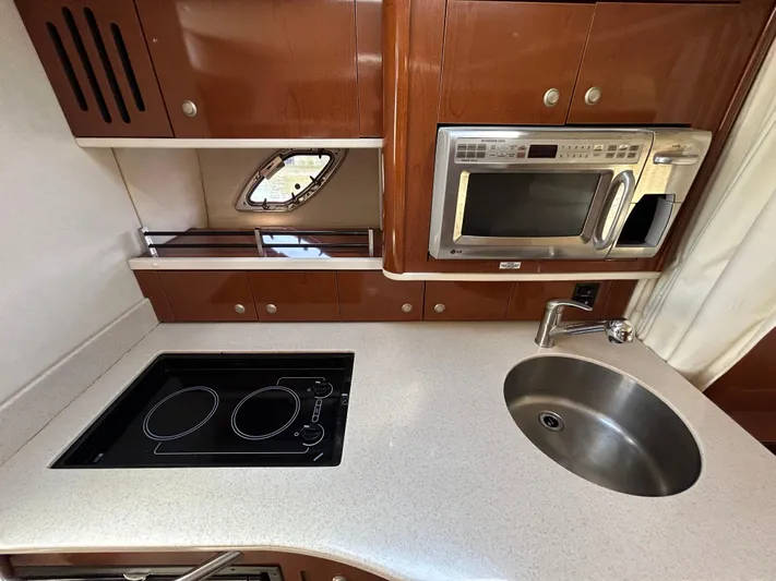  Yacht Photos Pics 2008 Sea Ray 330 Sundancer kitchen with stove, microwave, and sink.