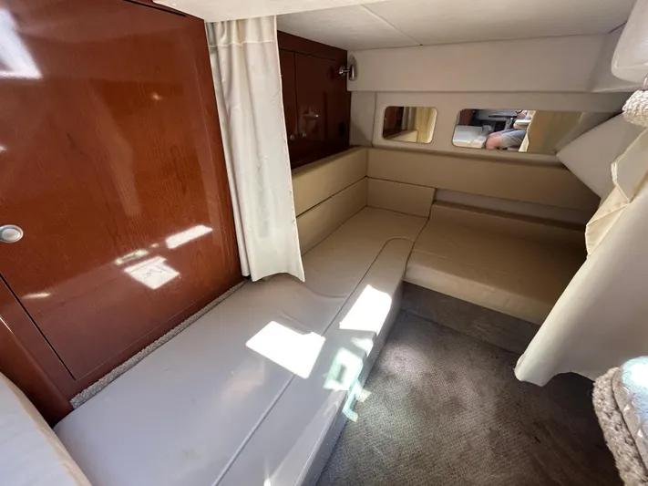  Yacht Photos Pics 2008 Sea Ray 330 Sundancer cabin interior with beige seating and wooden paneling.