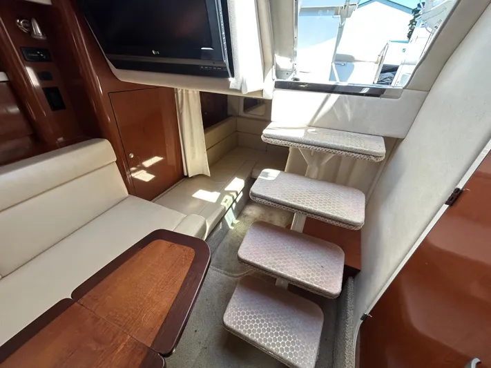  Yacht Photos Pics Interior of 2008 Sea Ray 330 Sundancer with stairs, seating, and wooden table.