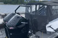 2022 Anytec A30 X-Tnd boat with dual Mercury outboard engines docked by a lake.
