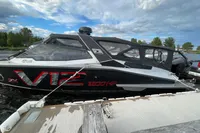 2022 Anytec A30 X-Tnd boat with V12 engine, docked under cloudy sky.