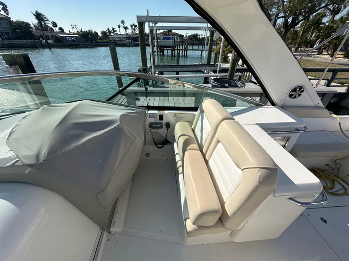  Yacht Photos Pics 2013 Sea Ray 370 Venture boat interior with helm and seating, docked by the water.
