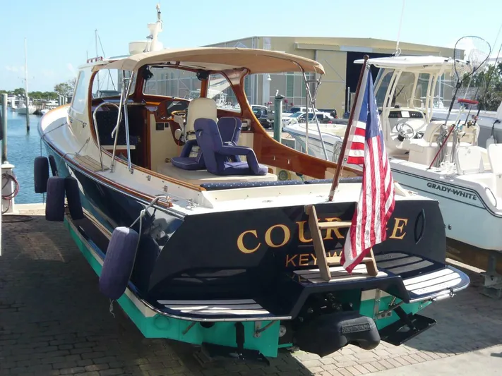 Courage Yacht Photos Pics 1998 Hinckley 36 Classic yacht docked, featuring an American flag and elegant design.