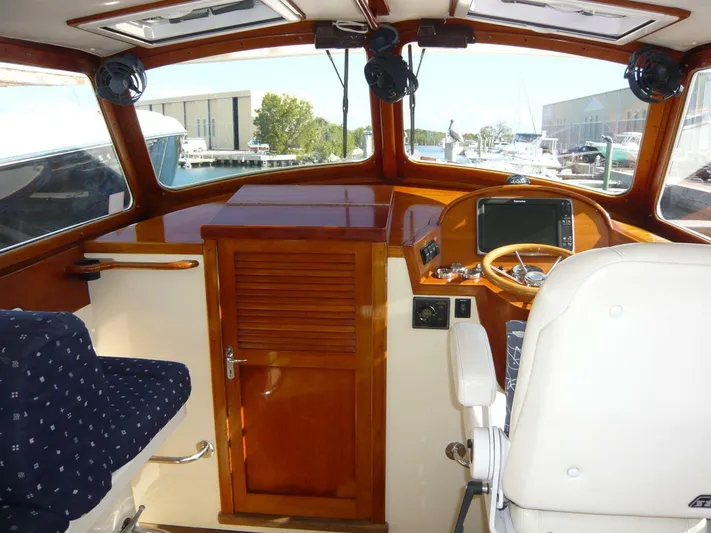 Courage Yacht Photos Pics Interior of 1998 Hinckley 36 Classic boat with polished wood and modern controls.