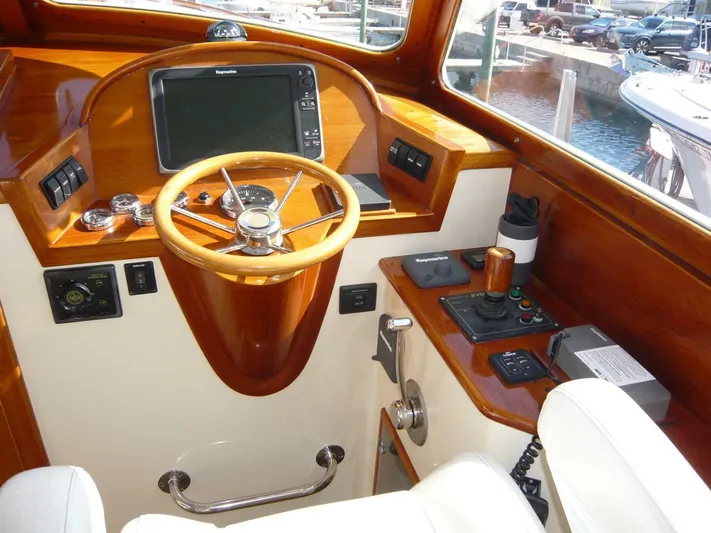 Courage Yacht Photos Pics 1998 Hinckley 36 Classic helm with wooden steering wheel and navigation equipment.
