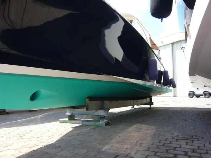 Courage Yacht Photos Pics Hinckley 36 Classic 1998 boat hull on dry dock, showcasing sleek design and vibrant colors.