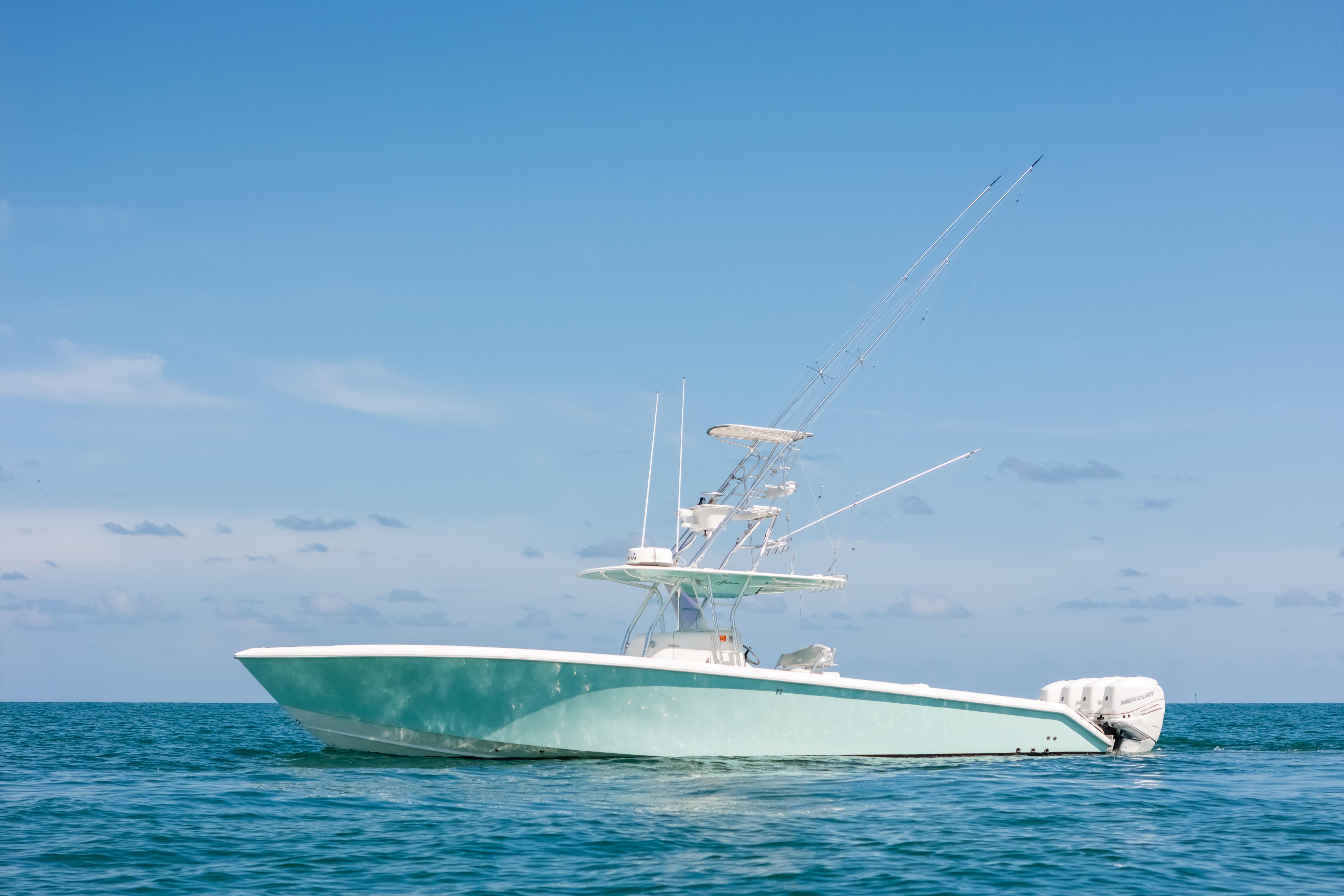 2006 Venture 39 Open boat on calm ocean under clear blue sky.