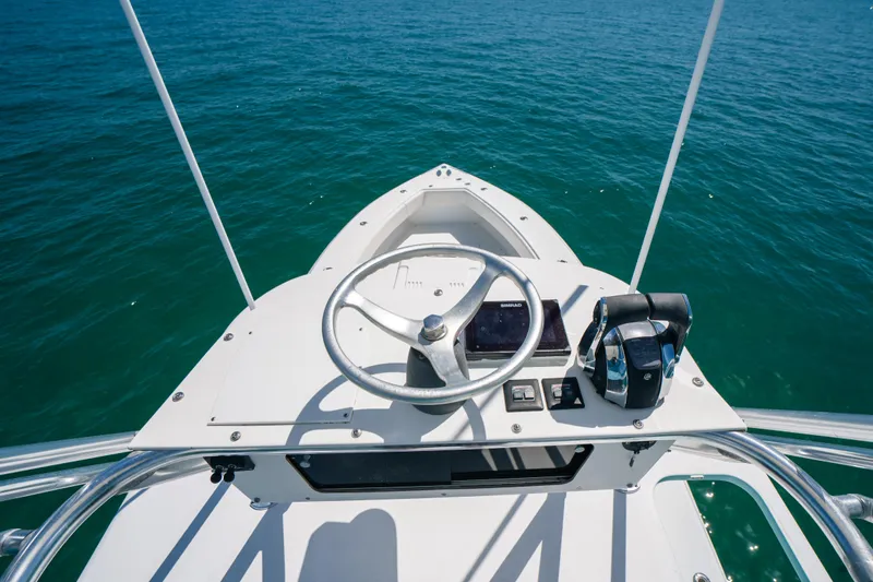  Yacht Photos Pics Steering console of 2006 Venture 39 Open boat on open water.