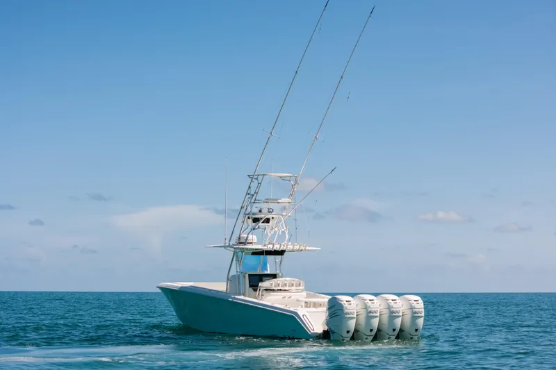  Yacht Photos Pics 2006 Venture 39 Open boat with four engines on open sea under clear sky.
