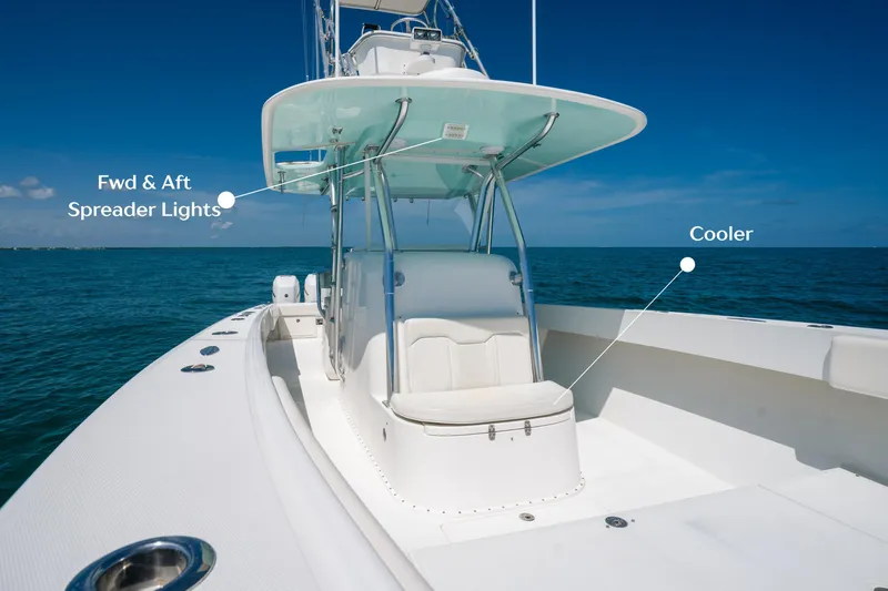  Yacht Photos Pics 2006 Venture 39 Open boat with spreader lights and cooler on deck, under clear blue sky.