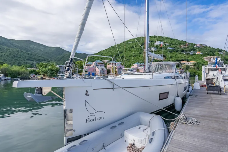Sunday Girl Yacht Photos Pics 2024 Beneteau Oceanis 51.1 yacht docked in scenic marina with lush hills.