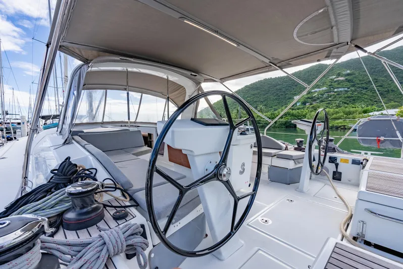 Sunday Girl Yacht Photos Pics 2024 Beneteau Oceanis 51.1 yacht cockpit with dual steering wheels and canopy.