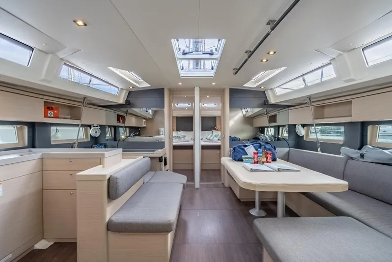 Sunday Girl Yacht Photos Pics Luxurious interior of 2024 Beneteau Oceanis 51.1 yacht with modern seating and ample natural light.