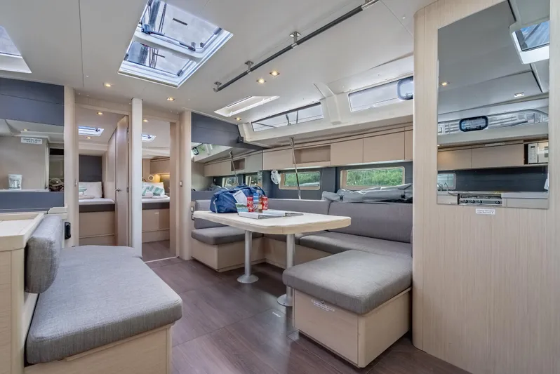 Sunday Girl Yacht Photos Pics Luxurious interior of 2024 Beneteau Oceanis 51.1 yacht with modern seating and skylights.