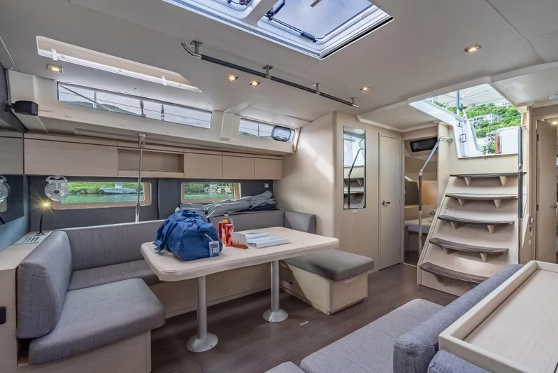 Sunday Girl Yacht Photos Pics Luxurious interior of 2024 Beneteau Oceanis 51.1 yacht with modern seating and ample natural light.