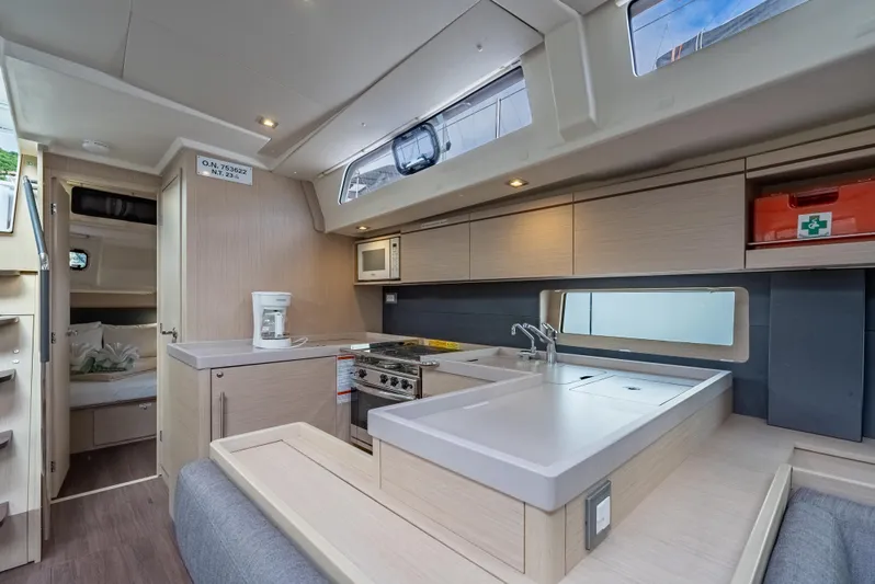 Sunday Girl Yacht Photos Pics 2024 Beneteau Oceanis 51.1 yacht interior with modern kitchen and cozy cabin.