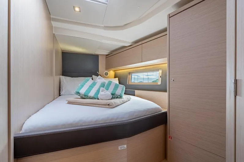 Sunday Girl Yacht Photos Pics Luxurious cabin interior of 2024 Beneteau Oceanis 51.1 yacht with cozy bedding.