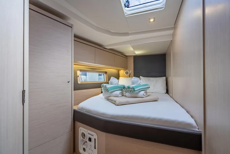 Sunday Girl Yacht Photos Pics Luxurious cabin interior of 2024 Beneteau Oceanis 51.1 yacht with cozy bedding.