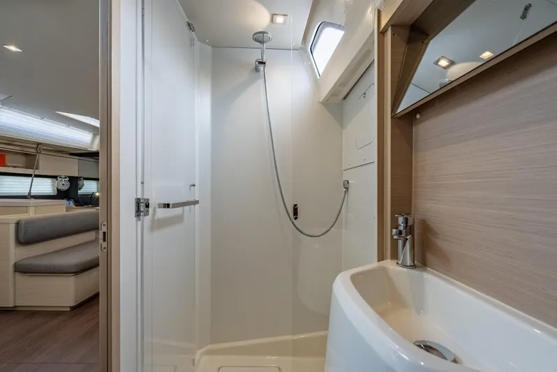 Sunday Girl Yacht Photos Pics Modern bathroom interior of 2024 Beneteau Oceanis 51.1 yacht, featuring sleek shower and sink.